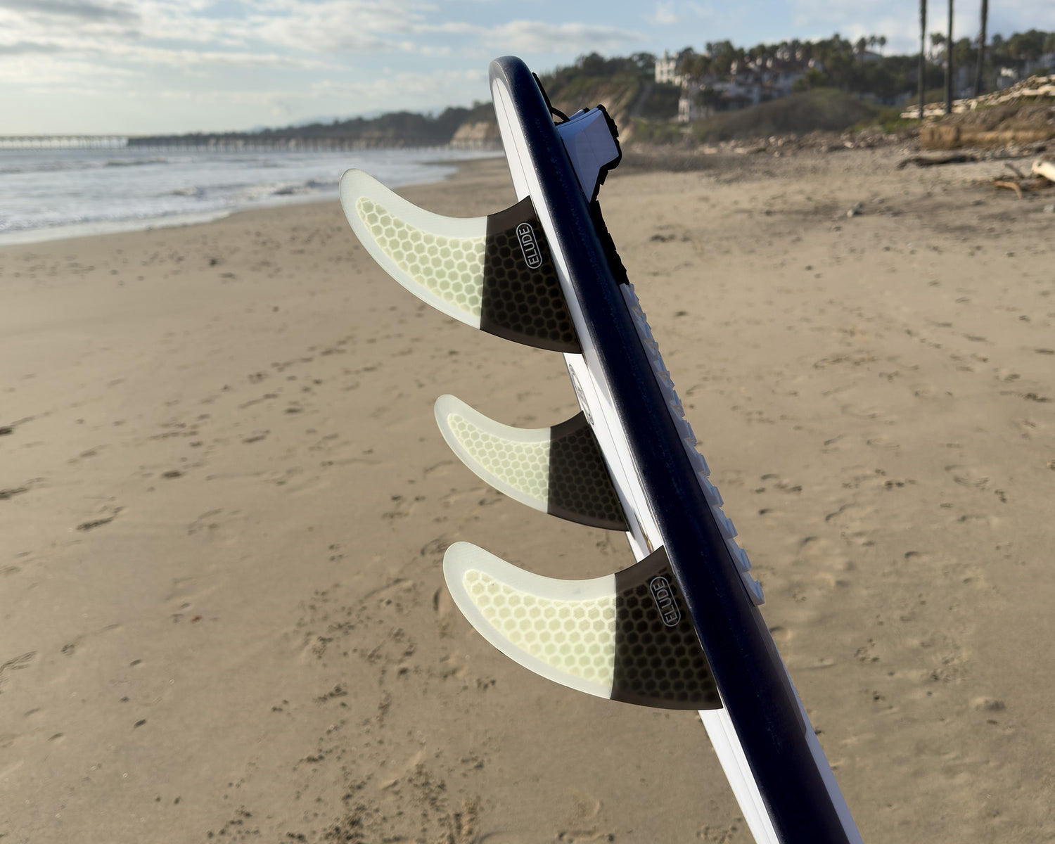 Hexcore thruster surfboard fins at beach