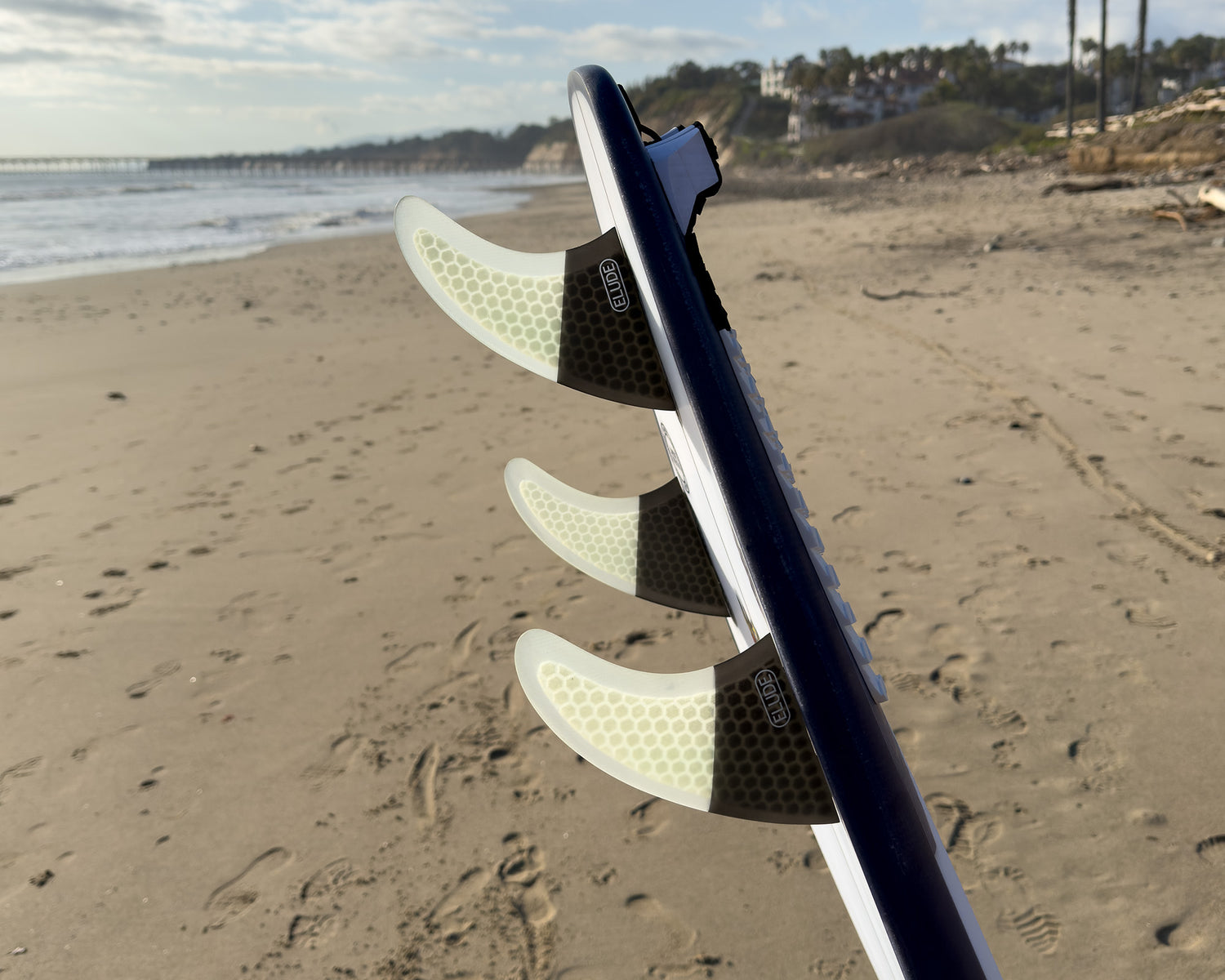 Hexcore thruster surfboard fins at beach
